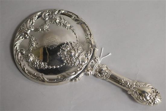 A repousse sterling silver hand mirror, 21.5cm.